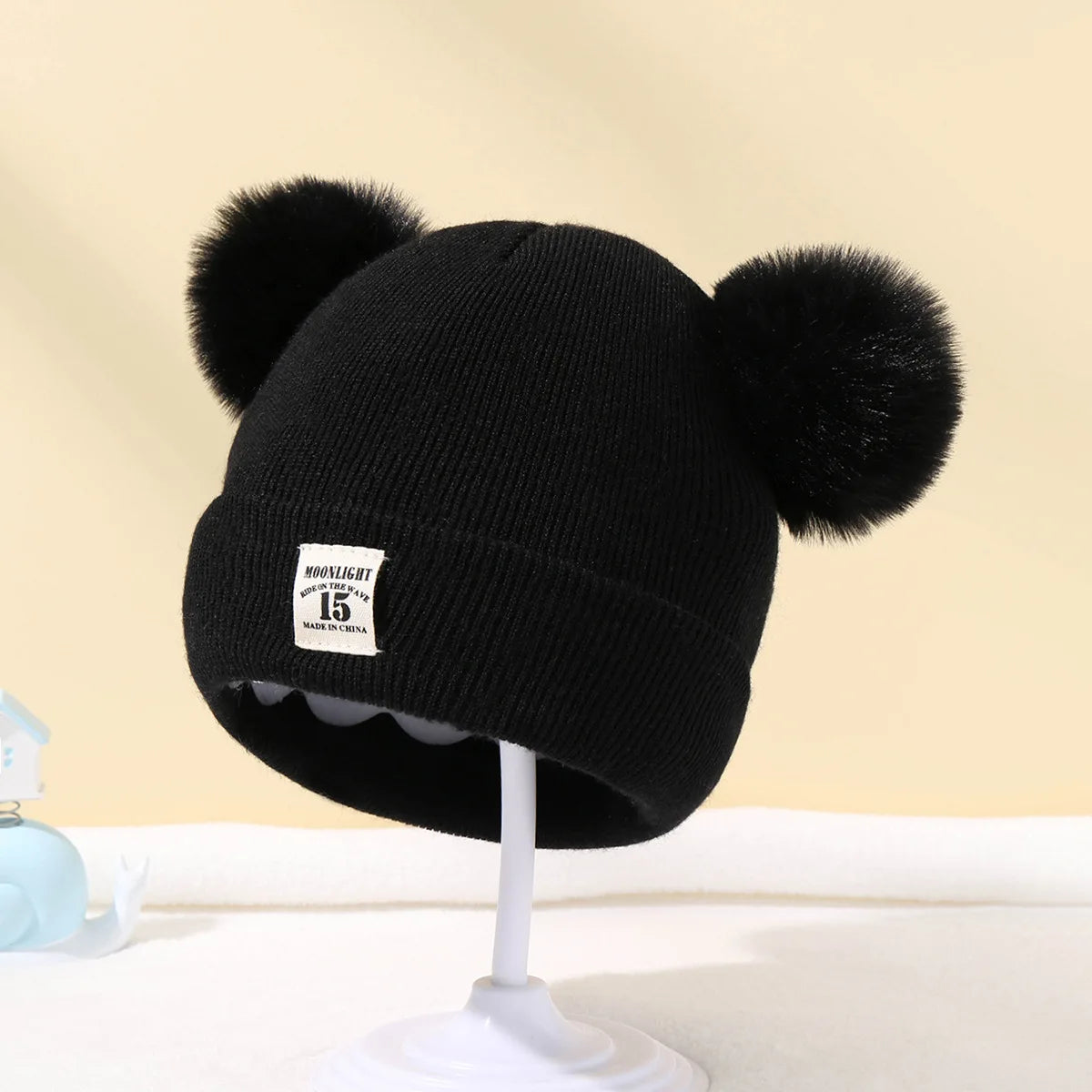 BORA kids pom pom hat in black with soft fur pom poms for stylish warmth
