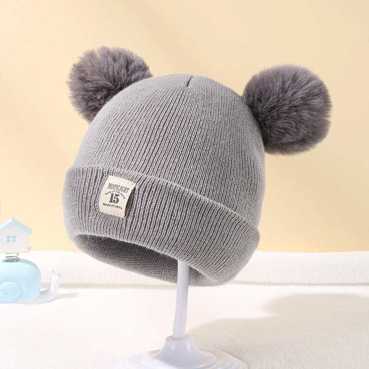 BORA kids pom pom hat in gray with two fluffy pom pom accents for stylish warmth