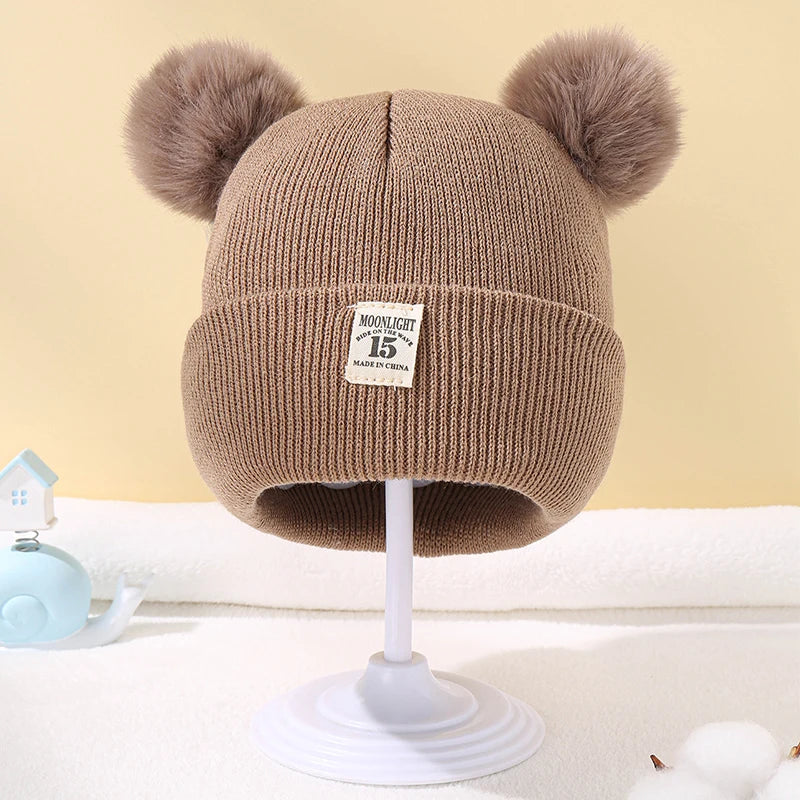 BORA kids pom pom hat in brown with cozy knit design and fluffy pom poms on top