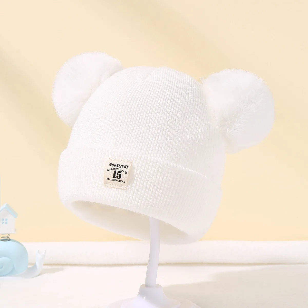 Cozy white kids pom pom hat featuring cute pom details for fun winter style