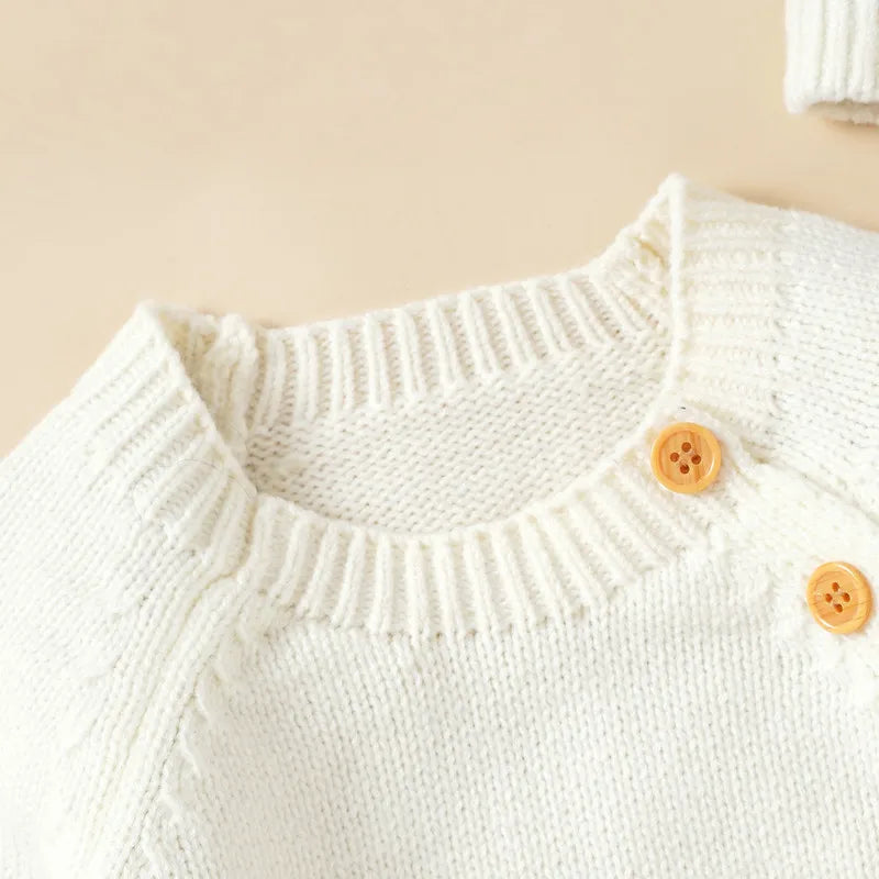 Newborn long sleeve romper with hat in cream featuring button closure and knit texture for cozy comfort