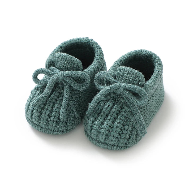 Knitted newborn baby shoes in green for infants with a stylish design, perfect toddler footwear fashion