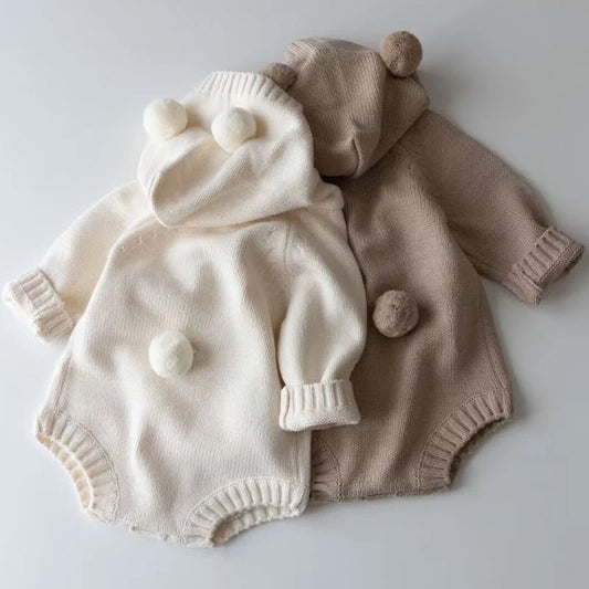 BORA Winter Baby Clothing Newborn Jumpsuit in cream and beige with pom-pom accents for cozy warmth