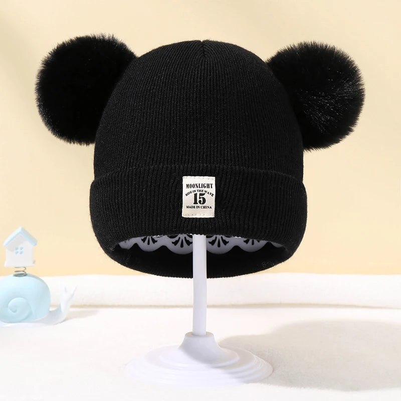 BORA kids pom pom hat in black with playful ear design and soft knit fabric